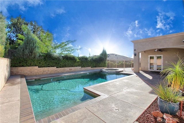 view of pool with an in ground hot tub, french doors, ceiling fan, and a patio area