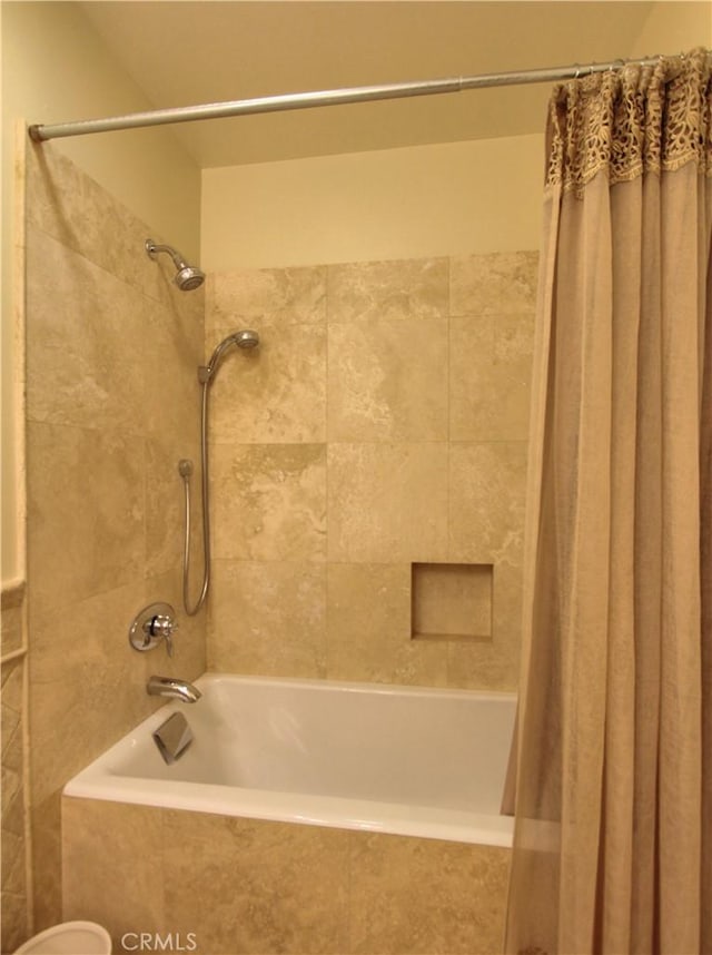 bathroom with shower / bath combination with curtain