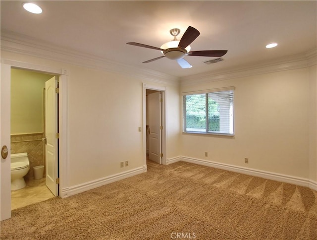 unfurnished bedroom with connected bathroom, ceiling fan, crown molding, and carpet