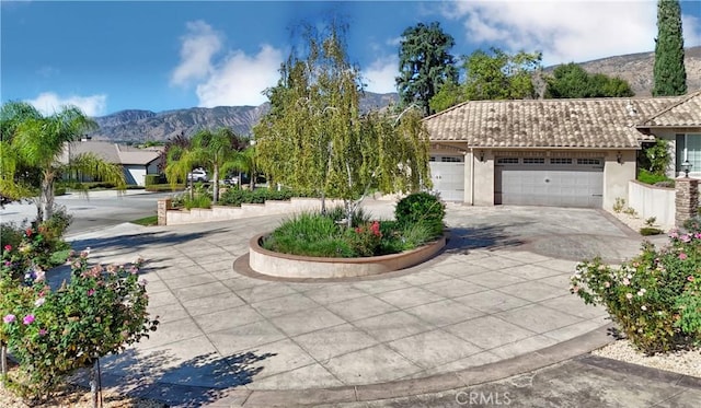 exterior space with a mountain view and a garage