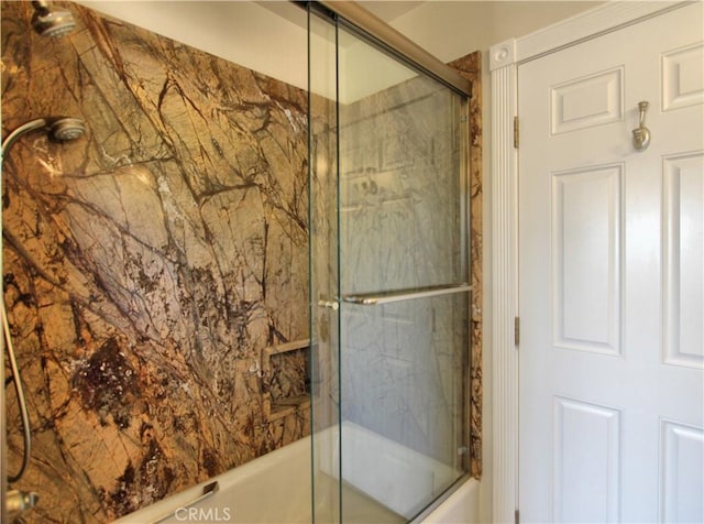 bathroom featuring shower / bath combination with glass door