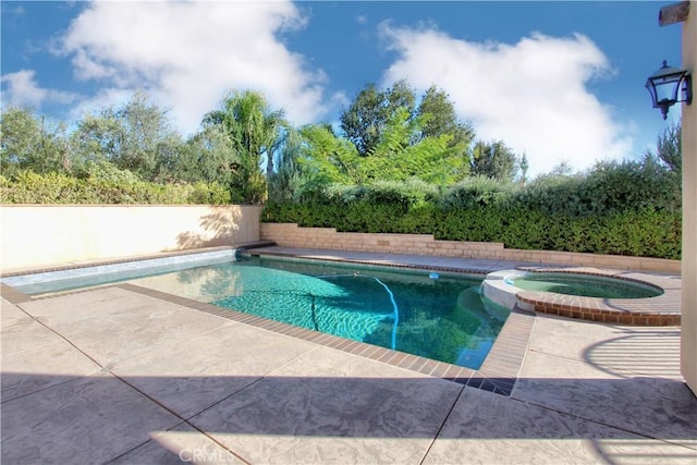 view of pool with an in ground hot tub