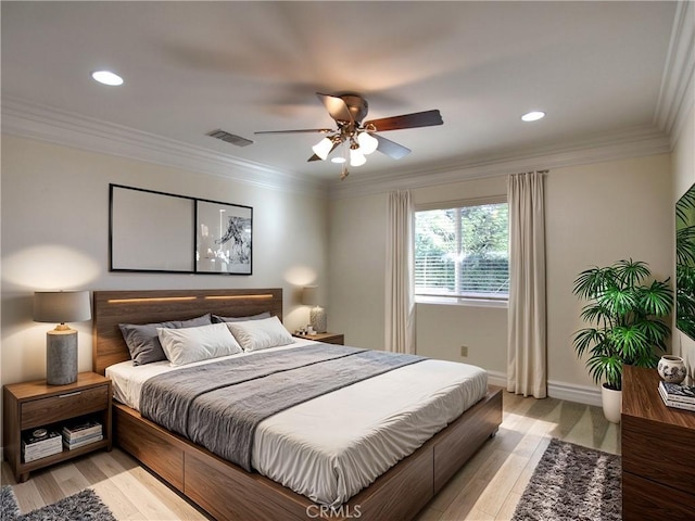 bedroom with ceiling fan, crown molding, and light hardwood / wood-style flooring