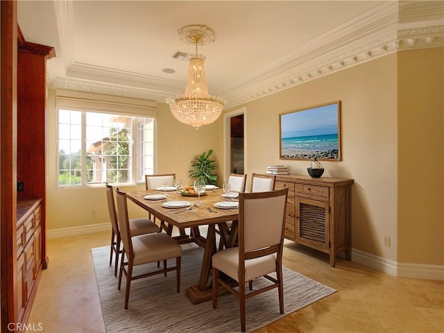 dining room featuring ornamental molding and a notable chandelier