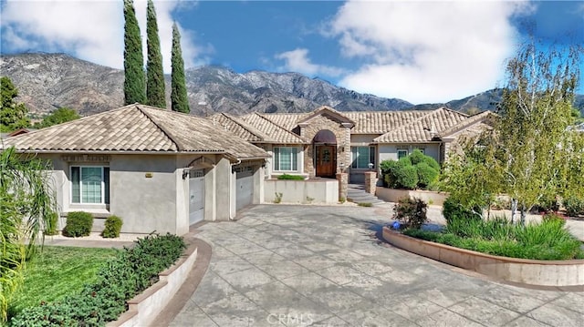 view of front of property featuring a mountain view and a garage