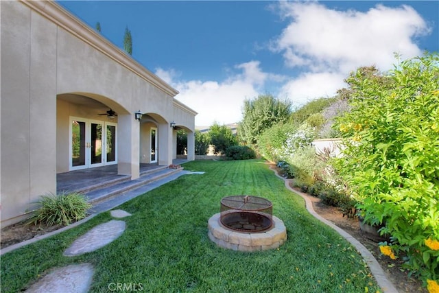 view of yard with a patio and a fire pit