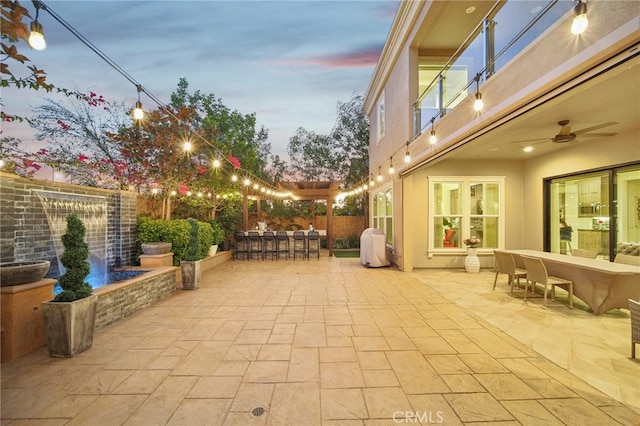 patio terrace at dusk with french doors and ceiling fan