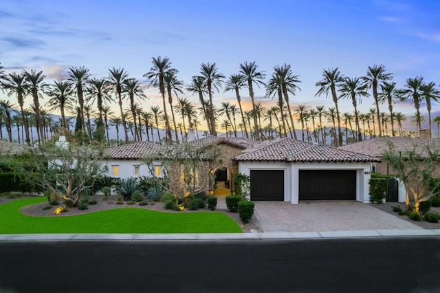 mediterranean / spanish house with a garage