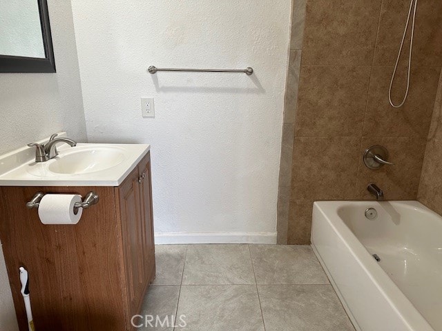 bathroom with tiled shower / bath, tile patterned floors, and vanity