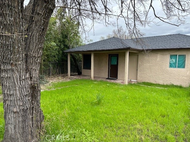 rear view of house with a lawn