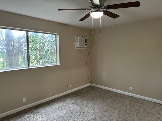 carpeted spare room featuring ceiling fan and a wall mounted AC