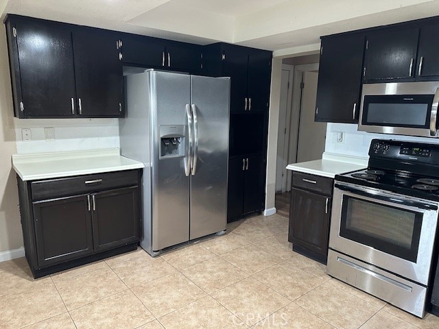 kitchen with stainless steel appliances and light tile patterned floors