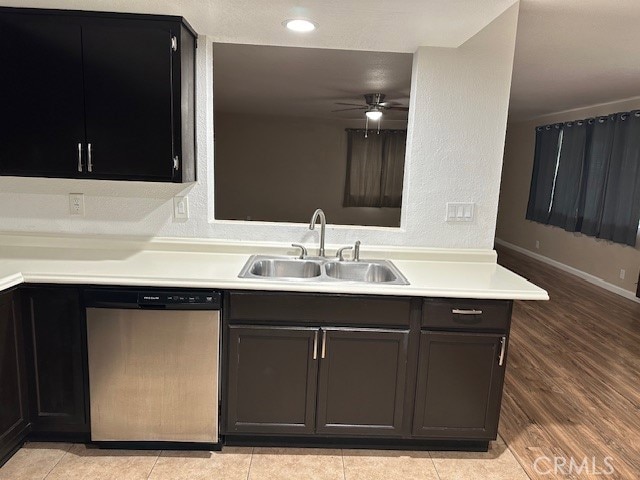 kitchen featuring light wood-type flooring, ceiling fan, sink, kitchen peninsula, and dishwasher