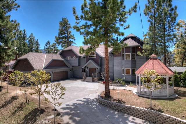 view of front of property with a garage and a gazebo