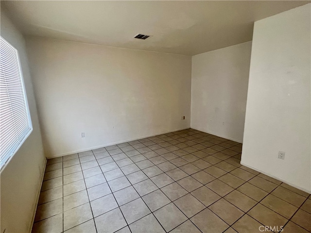 spare room featuring light tile patterned flooring