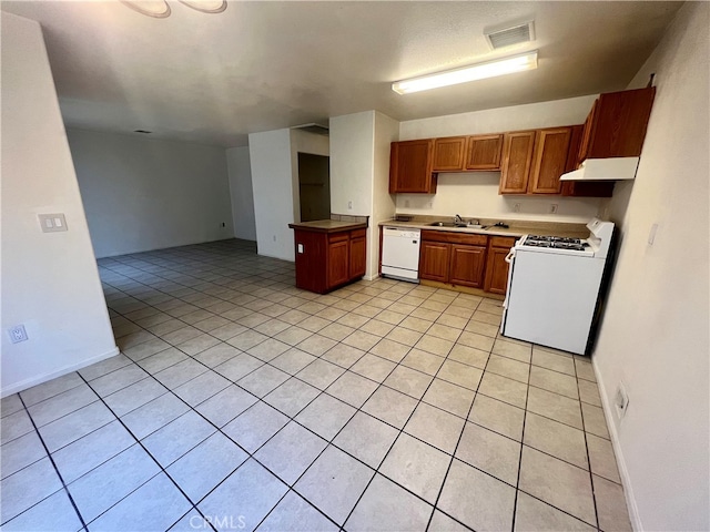 kitchen featuring light tile patterned flooring, white appliances, and sink