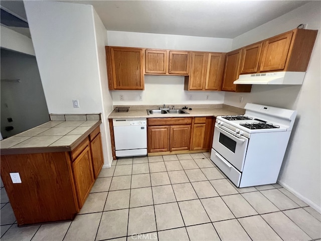 kitchen with light tile patterned flooring, sink, and white appliances