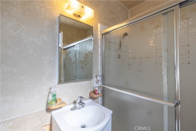 bathroom with sink and walk in shower