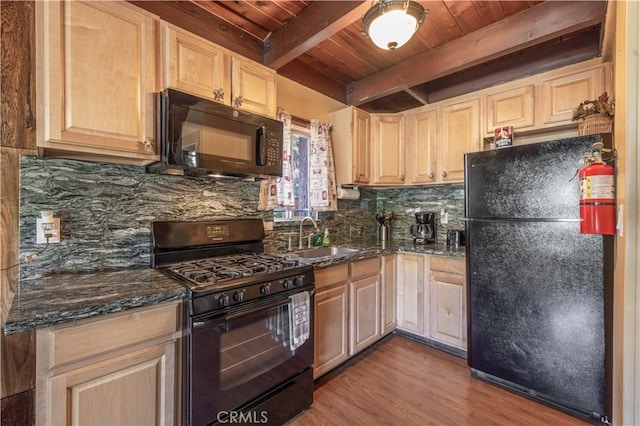 kitchen with wood ceiling, beam ceiling, sink, black appliances, and dark stone countertops