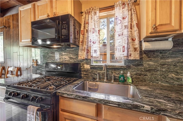 kitchen featuring black appliances, dark stone counters, sink, and tasteful backsplash