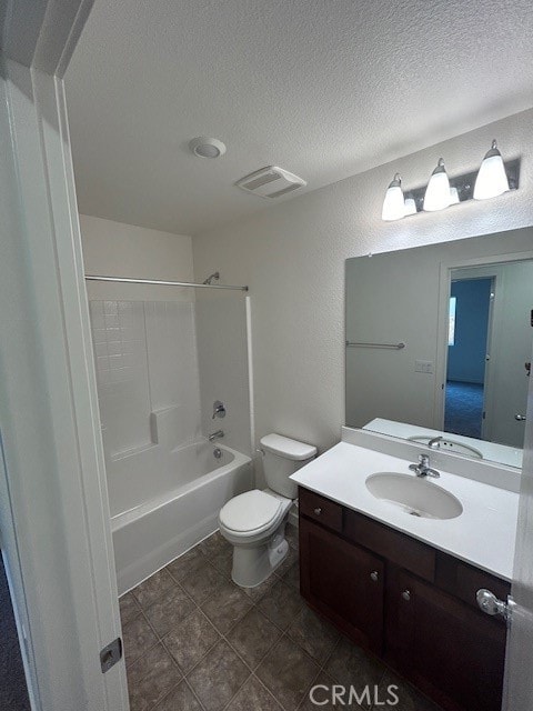 full bathroom with toilet, tile patterned floors, bathtub / shower combination, vanity, and a textured ceiling