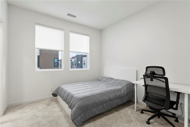 bedroom featuring light carpet