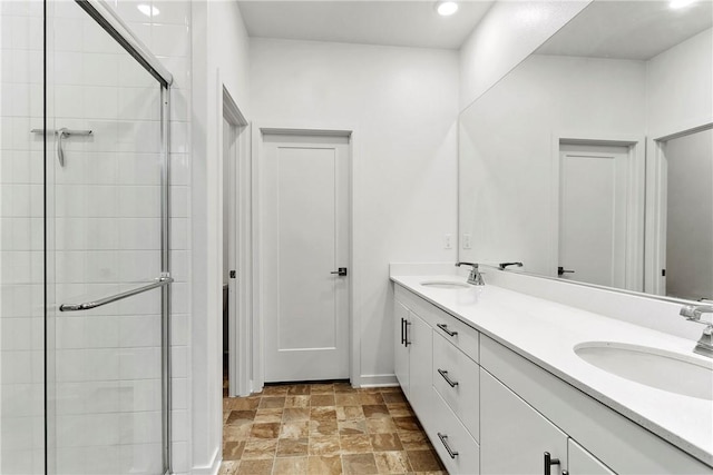 bathroom with vanity and a shower with shower door