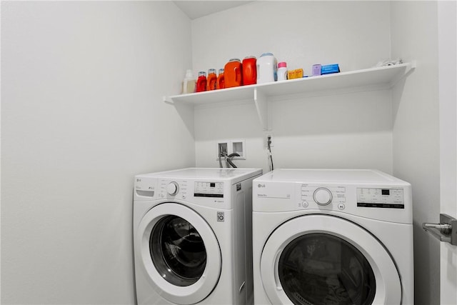 clothes washing area with separate washer and dryer