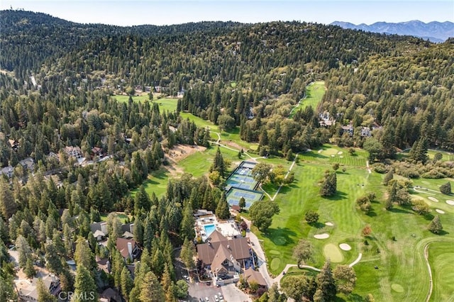 birds eye view of property featuring a forest view, a mountain view, and golf course view