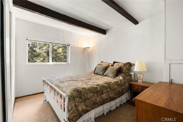 carpeted bedroom featuring beam ceiling