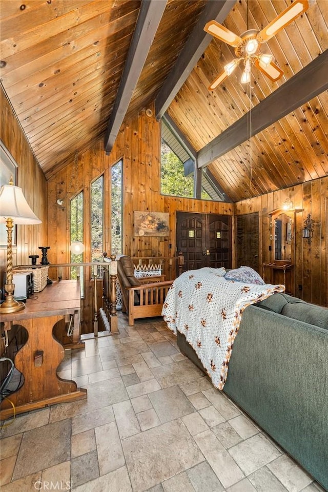 bedroom featuring wood walls, vaulted ceiling with beams, and stone tile floors