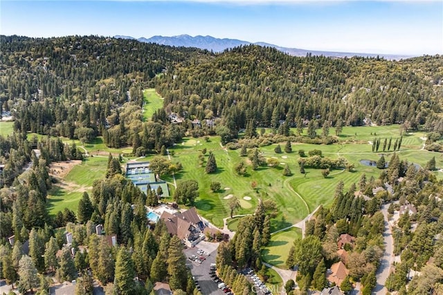 birds eye view of property with golf course view, a forest view, and a mountain view