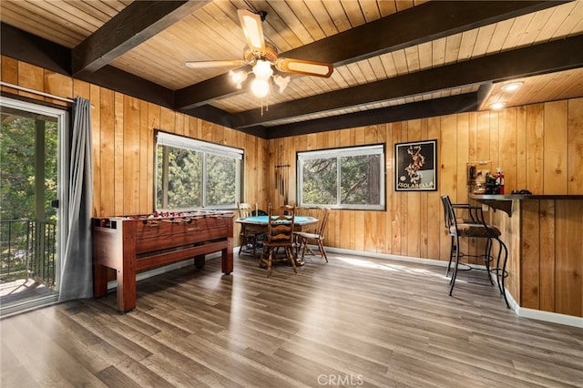 living area featuring hardwood / wood-style flooring, wood walls, wooden ceiling, and a wealth of natural light