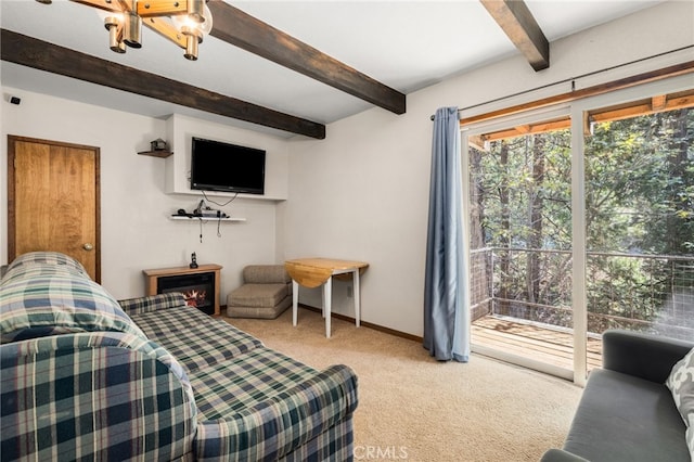 bedroom with access to exterior, beam ceiling, and light carpet