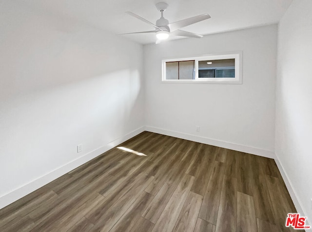 unfurnished room featuring ceiling fan and dark hardwood / wood-style floors