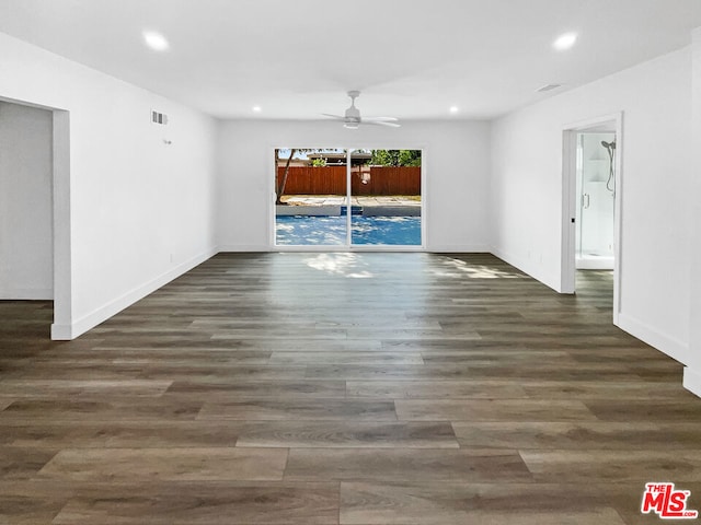 spare room with ceiling fan and dark wood-type flooring