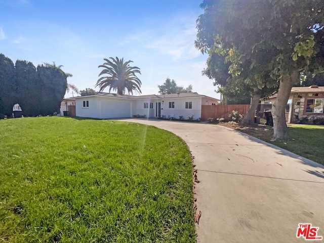 view of front of house featuring a front yard and a garage