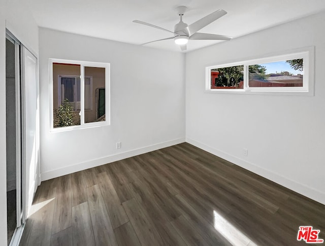 unfurnished room featuring dark hardwood / wood-style floors and ceiling fan