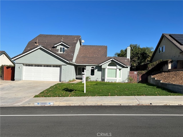 view of front facade featuring a front yard and a garage