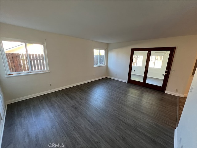 unfurnished room featuring french doors, plenty of natural light, and dark hardwood / wood-style floors