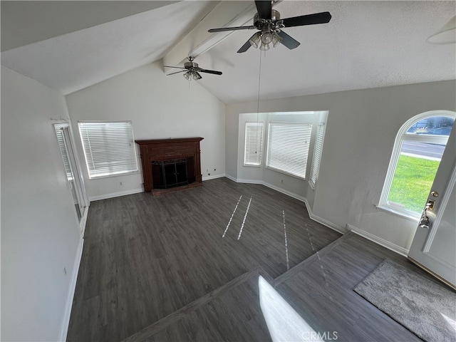 unfurnished living room with dark hardwood / wood-style floors, lofted ceiling with beams, and ceiling fan