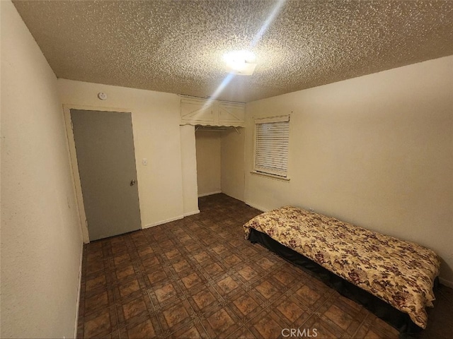 unfurnished bedroom featuring a closet and a textured ceiling