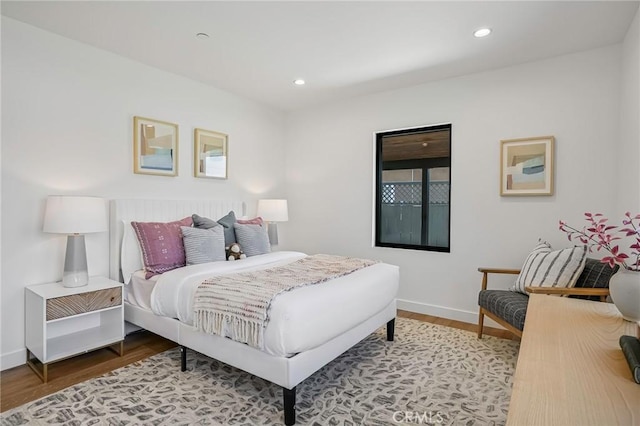 bedroom with recessed lighting, baseboards, and wood finished floors