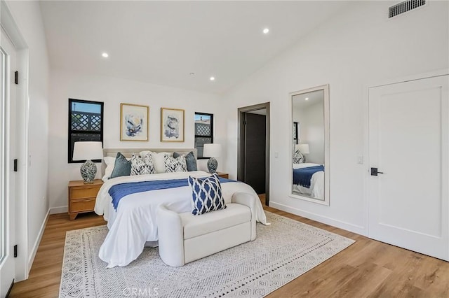 bedroom featuring visible vents, recessed lighting, wood finished floors, and vaulted ceiling