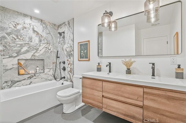 full bath featuring tile patterned floors, toilet, a sink, shower / washtub combination, and double vanity