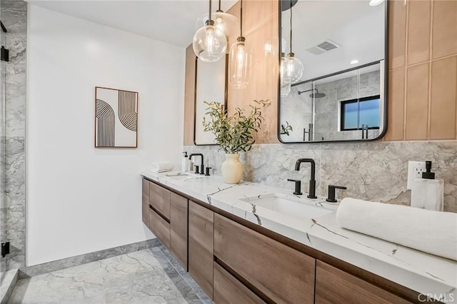 bathroom with visible vents, marble finish floor, a stall shower, and a sink