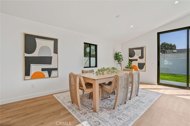 dining space featuring recessed lighting, baseboards, light wood-type flooring, and lofted ceiling