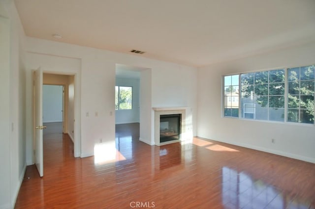 unfurnished living room featuring hardwood / wood-style flooring