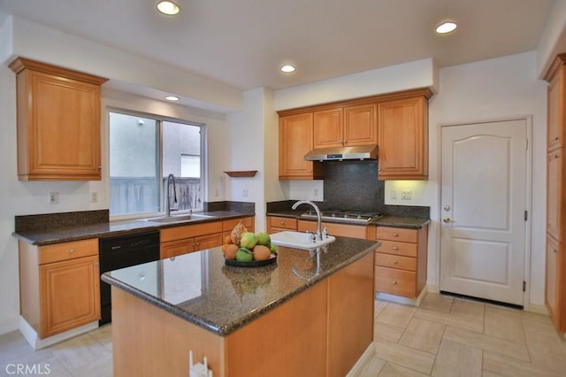 kitchen featuring stainless steel gas cooktop, a kitchen island with sink, dishwasher, and sink