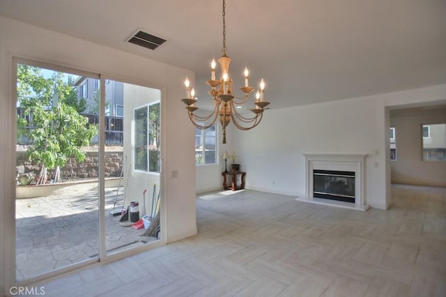 unfurnished living room featuring an inviting chandelier